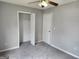 Cozy bedroom featuring neutral carpet, a ceiling fan, closet and natural lighting at 4687 Sterling Pointe Ct, Douglasville, GA 30135