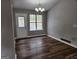 Bright dining room featuring vinyl flooring, a modern chandelier, a window, and backyard access at 4687 Sterling Pointe Ct, Douglasville, GA 30135