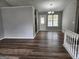 Open dining area with luxury vinyl plank flooring, natural lighting and modern light fixtures at 4687 Sterling Pointe Ct, Douglasville, GA 30135