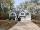 Charming two-story home with a well-manicured lawn and a two-car garage surrounded by mature trees and blossoming flowers at 4687 Sterling Pointe Ct, Douglasville, GA 30135