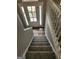 View of foyer featuring carpeted stairs with white railing and a front door with sidelights at 4687 Sterling Pointe Ct, Douglasville, GA 30135