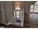 View of foyer featuring updated lighting, luxury vinyl flooring, and staircase at 4687 Sterling Pointe Ct, Douglasville, GA 30135