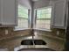Kitchen area featuring granite countertops, tile backsplash, stainless steel sink, and garden view at 4687 Sterling Pointe Ct, Douglasville, GA 30135