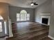 Spacious living room boasting hardwood floors, a fireplace, and a large window offering natural light at 4687 Sterling Pointe Ct, Douglasville, GA 30135