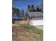 View of the side of the house, showing the garage and a wooden fence bordering the backyard at 172 Willow Springs Ln, Stockbridge, GA 30281