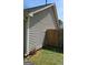 Side yard featuring a wooden fence and exterior vinyl siding, perfect for enjoying outdoor living at 172 Willow Springs Ln, Stockbridge, GA 30281