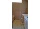 View of bathroom with patterned wallpaper, tile flooring, tub, and window at 172 Willow Springs Ln, Stockbridge, GA 30281