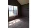 Bedroom with carpet, large window, and dark-colored walls at 172 Willow Springs Ln, Stockbridge, GA 30281