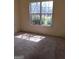 Bedroom featuring carpet flooring, a window with a view, and electrical outlet at 172 Willow Springs Ln, Stockbridge, GA 30281