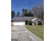 Charming single-story home with a two-car garage and well-maintained front lawn and lovely red shutters at 172 Willow Springs Ln, Stockbridge, GA 30281