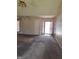 View of the living room, showing a ceiling fan, carpeted floor and an open front doorway at 172 Willow Springs Ln, Stockbridge, GA 30281