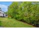 Tree-lined backyard featuring a well maintained lawn and perimeter fencing at 3121 Cruse Rd, Lawrenceville, GA 30044