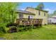 Exterior view of the home's rear facade and deck with steps leading down to the yard at 3121 Cruse Rd, Lawrenceville, GA 30044