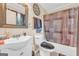 Traditional bathroom featuring a vanity, toilet, and a shower with a patterned curtain at 3121 Cruse Rd, Lawrenceville, GA 30044