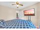 Bedroom features blue patterned bedding, television, and easy access to other areas at 3121 Cruse Rd, Lawrenceville, GA 30044