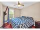 Comfortable bedroom with blue patterned bedding, a window, and ceiling fan at 3121 Cruse Rd, Lawrenceville, GA 30044