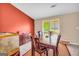 Bright dining room with a dark wood table, accent wall, and large window at 3121 Cruse Rd, Lawrenceville, GA 30044
