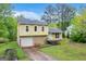 Charming two-story home featuring an attached garage and well-manicured lawn at 3121 Cruse Rd, Lawrenceville, GA 30044