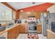 Functional kitchen with oak cabinets, stainless steel appliances, and a bright window at 3121 Cruse Rd, Lawrenceville, GA 30044