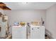 Functional laundry room with washer, dryer, and utility sink at 3121 Cruse Rd, Lawrenceville, GA 30044