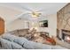 Inviting living room with stone fireplace, large sectional sofa, and bright, natural light at 3121 Cruse Rd, Lawrenceville, GA 30044