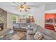 Spacious living room featuring a stone fireplace, large sectional sofa, and open floorplan at 3121 Cruse Rd, Lawrenceville, GA 30044