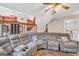 Open-concept living room with stone fireplace, large sectional sofa, and a staircase at 3121 Cruse Rd, Lawrenceville, GA 30044