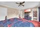 This expansive main bedroom features neutral walls, red carpet, and a large tv at 3121 Cruse Rd, Lawrenceville, GA 30044