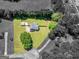 Aerial view of home showing well-manicured lawn, fenced-in backyard, and mature trees at 303 Mill Glen Ct, Mcdonough, GA 30252