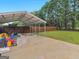 Large open carport next to the lawn in the backyard at 303 Mill Glen Ct, Mcdonough, GA 30252