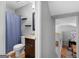 Bathroom with dark wood vanity and shower with blue curtain at 303 Mill Glen Ct, Mcdonough, GA 30252