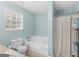 Bright bathroom with a soaking tub, updated fixtures, and a tiled floor at 303 Mill Glen Ct, Mcdonough, GA 30252