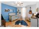 Bright bedroom with wood floor and blue accent wall at 303 Mill Glen Ct, Mcdonough, GA 30252