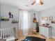 Bright bedroom with wood floors and a view of the front yard at 303 Mill Glen Ct, Mcdonough, GA 30252