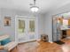 Bright dining area with hardwood floors, a walkout to the deck, and a kitchen area at 303 Mill Glen Ct, Mcdonough, GA 30252
