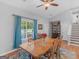 Bright dining room boasts natural light, a wooden table, and easy access to other living spaces at 303 Mill Glen Ct, Mcdonough, GA 30252