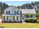 Charming two-story home with a manicured lawn and gray siding at 303 Mill Glen Ct, Mcdonough, GA 30252