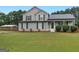 Charming two-story home with manicured lawn and attractive landscaping at 303 Mill Glen Ct, Mcdonough, GA 30252