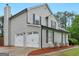 A two-car garage is attached to the home, offering ample parking space at 303 Mill Glen Ct, Mcdonough, GA 30252