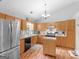 Kitchen with stainless steel refrigerator, light wood cabinets, and modern appliances at 303 Mill Glen Ct, Mcdonough, GA 30252