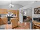 Bright, open kitchen with wood floors, cabinets, and stainless steel appliances at 303 Mill Glen Ct, Mcdonough, GA 30252