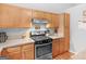 Well-lit kitchen featuring wooden cabinets, granite countertops, and stainless-steel appliances at 303 Mill Glen Ct, Mcdonough, GA 30252