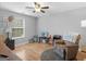 Cozy living room with hardwood floors, ceiling fan, and comfortable recliner at 303 Mill Glen Ct, Mcdonough, GA 30252