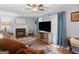 Bright living room with a fireplace, wood-look floors and barn door media console at 303 Mill Glen Ct, Mcdonough, GA 30252