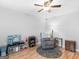 Cozy living room with hardwood floors, comfortable recliner, and a play area at 303 Mill Glen Ct, Mcdonough, GA 30252