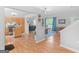 Open-concept living space with hardwood floors, a kitchen, and a dining area at 303 Mill Glen Ct, Mcdonough, GA 30252