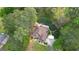 Aerial view of a two-story home with a brown roof and landscaped front yard surrounded by lush greenery at 4360 Derrick Rd, South Fulton, GA 30349