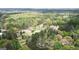 An aerial view of a home surrounded by dense trees in a forest area. The home is circled in white at 4360 Derrick Rd, South Fulton, GA 30349