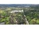 An aerial view of a home surrounded by dense trees in a forest area. The home is circled in white at 4360 Derrick Rd, South Fulton, GA 30349