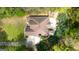 Aerial view of a two-story home featuring a brown roof, a patio, and a driveway, surrounded by lush greenery at 4360 Derrick Rd, South Fulton, GA 30349